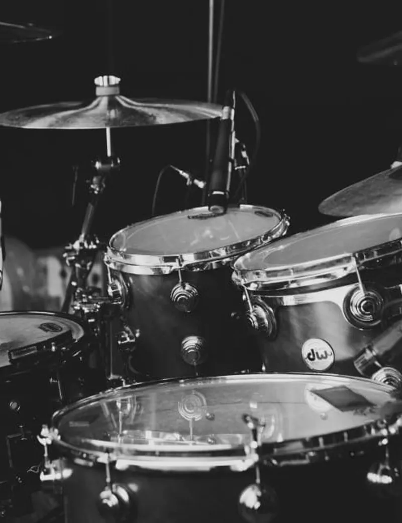 Close-up of a DW drum kit on a dark stage
